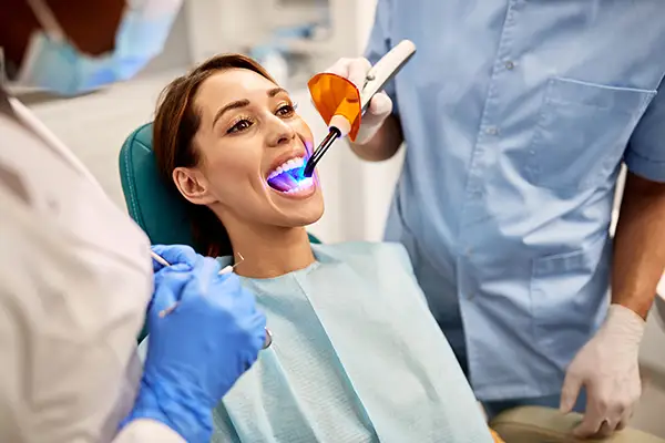 Image of a woman getting dental sealant treatment.